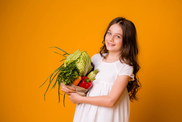 cute little girl holding vegetables, harvest concept  - Photo, image