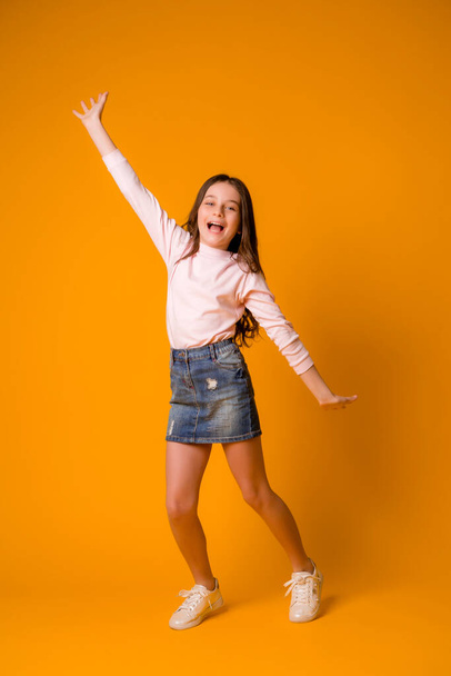 cute little girl in studio over orange background - Photo, Image