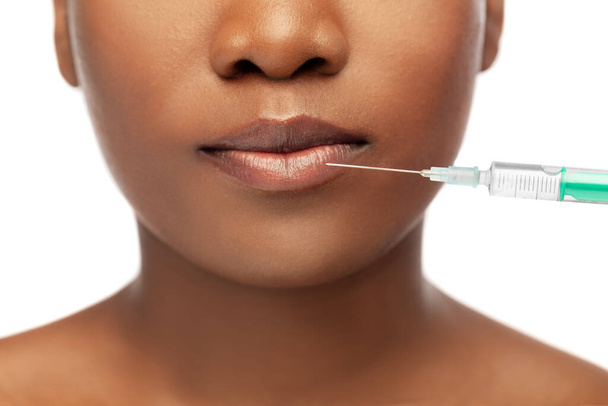 lips of african american woman and syringe - 写真・画像