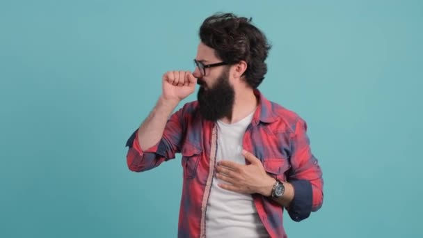 Young caucasian handsome man coughing, concept of virus or disease - Footage, Video
