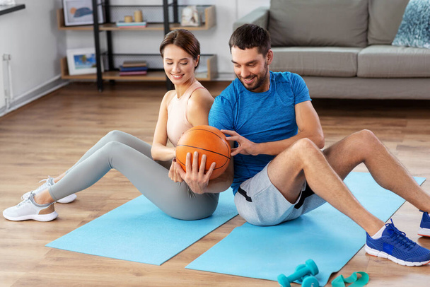 happy couple exercising with ball at home - Photo, image
