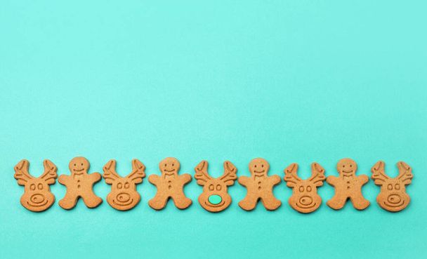 Christmas or new year composition. Homemade winter gingerbread cookies on paper blue mint background. AI Aqua - trendy color of the year 2021. Flat lay. Top view. - Foto, immagini