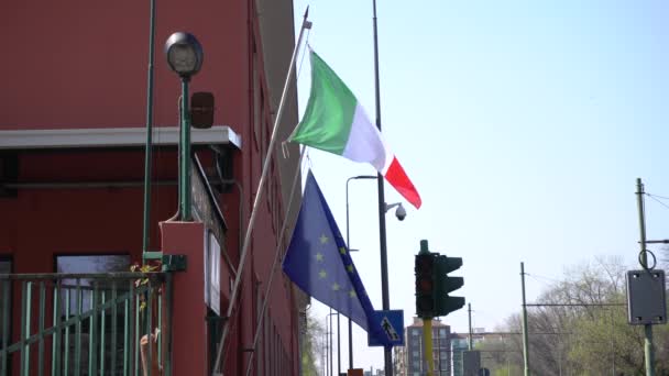 Eurooppa, Italia, Milano - Italian ja Euroopan unionin lippu roikkuu talon parvekkeella n-koven19 Coronavirus-epidemian aikana - Materiaali, video