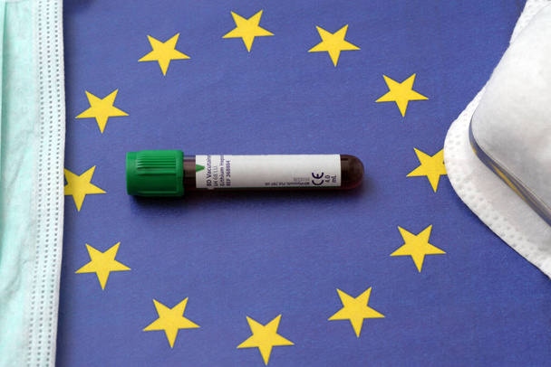 θετική εξέταση αίματος για τον νέο ταχέως εξαπλούμενο ιό Coronavirus n-cov19, καταγωγής Wuhan της Κίνας και άφιξη στην Ευρώπη - σημαία της Ευρωπαϊκής Ένωσης - Φωτογραφία, εικόνα
