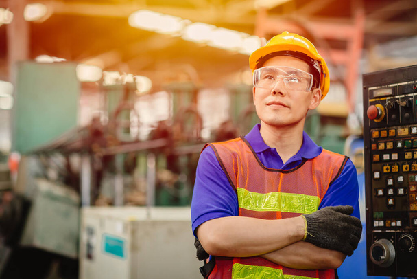 Portrait of Asian Chinese labor happy worker smiling looking for the future in a heavy industrial factory. - Photo, Image