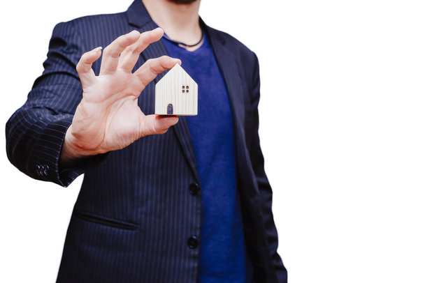 Business man hand holding home model with white space background for house mortgage adversiting concept. - Photo, Image