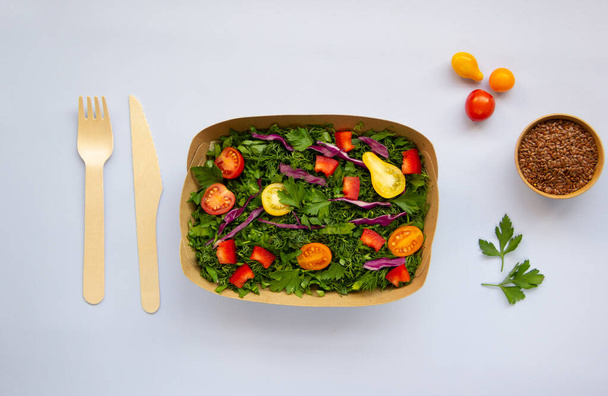 Green vegan salad made from a mixture of green leaves and vegetables. Healthy nutrition concept. Top view, flat lay, copy space. - Фото, изображение