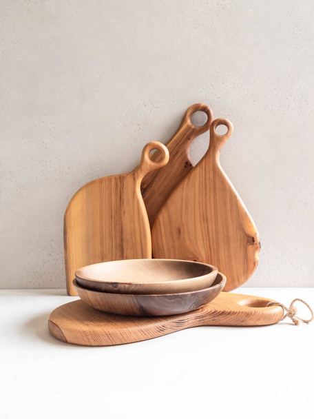 Set of wooden kitchenware - cutting board and bowls. copy space - Photo, Image