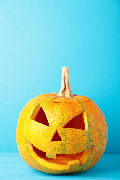 Halloween pumpkin head jack lantern on blue background. Top view - Photo, Image