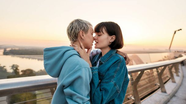 Young passionate lesbian couple going to kiss, Two girls enjoying romantic moments together at sunrise - Fotografie, Obrázek