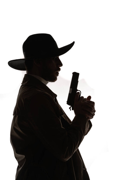 Profile shot of an attractive young guy posing in modern style cowboy clothes - Photo, Image