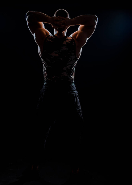 Front view body of muscular biceps sportsman or bodybuilder isolate on black background - Photo, image
