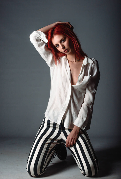 Studio body shot of an attractive woman posing in stylish clothes - Valokuva, kuva