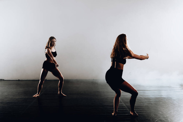 Caucasian female contemporary dancers exercising a dance routine - Фото, зображення