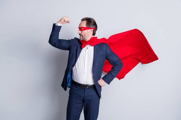 I am best. Photo of confident courage professional mature business man super hero costume character show biceps arrogant wear blue suit red face mask cloak isolated grey background - Foto, immagini