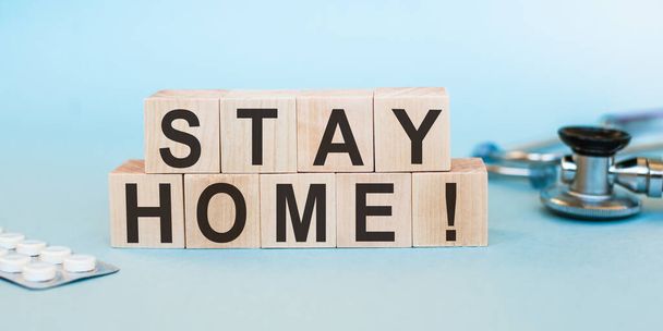wooden blocks write the word stay home for prevent and spread of coronavirus or COVID-19 concept - Фото, изображение
