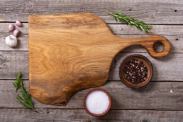 Rustic cutting board on wooden background . Food foto - Photo, Image