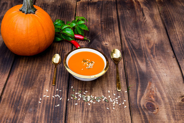 Vegetarian autumn pumpkin cream soup with seeds. Autumn food concept. - Фото, изображение