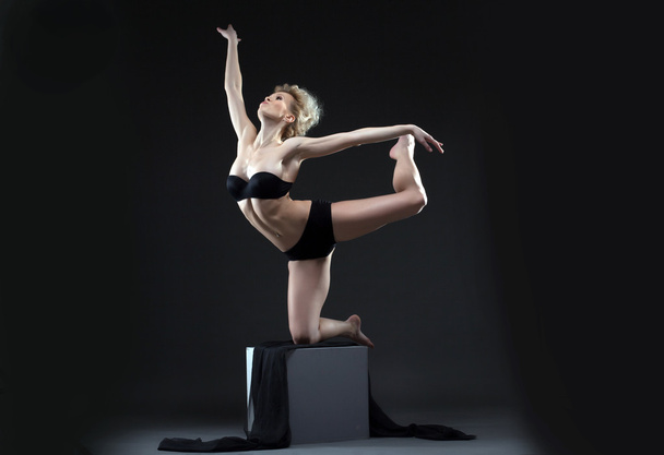 Image of seductive young dancer balancing on cube - Фото, изображение