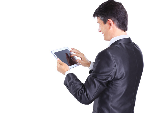 Businessman using a tablet computer - isolated over a white background - Foto, Imagen