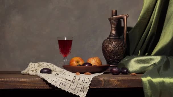 Still life with a bottle of wine, apples and plums. - Footage, Video