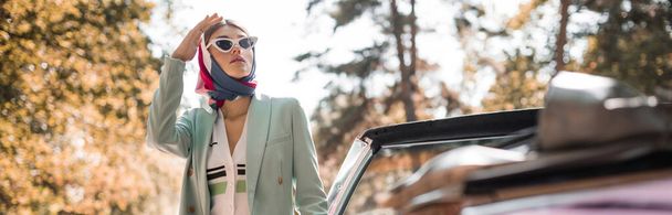 Stylish woman looking away near cabriolet car outdoors, banner - Foto, immagini