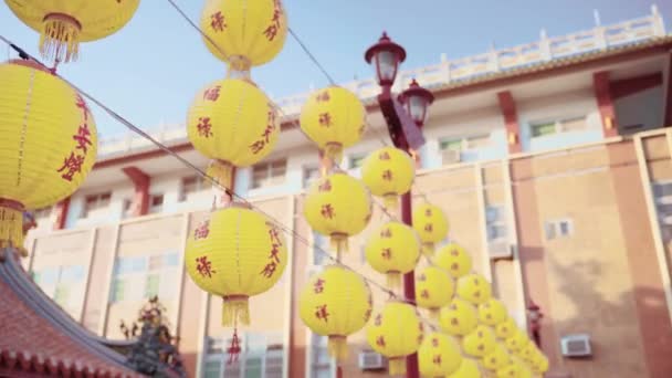 Some yellow lanterns labeled auspicious words hung up at Nan Kun Shen Dai Tian Temple in Taiwan. There are beautiful and decorated buildings surrounded. - Footage, Video