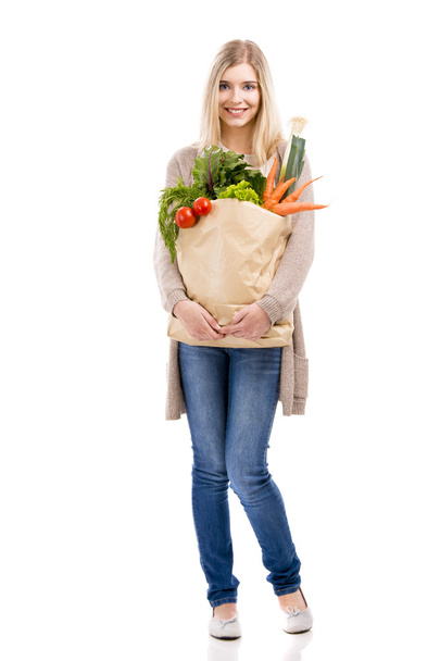 Woman carrying bag of vegetables - Photo, Image