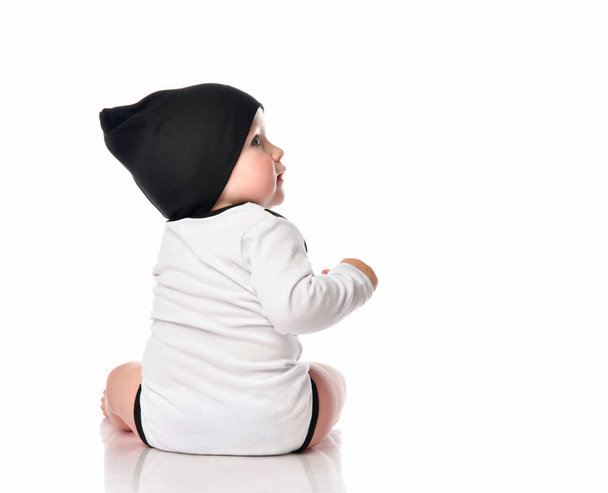 Child baby toddler sitting facing backwards from the back isolated on a white background. - Φωτογραφία, εικόνα