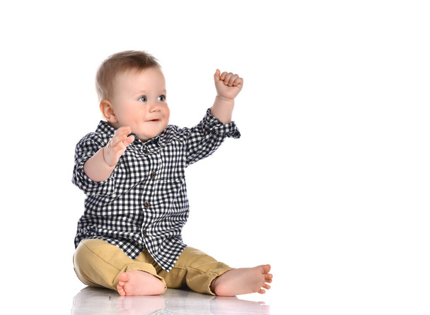 Little boy pulls his hands up in the studio on a white background. - Zdjęcie, obraz