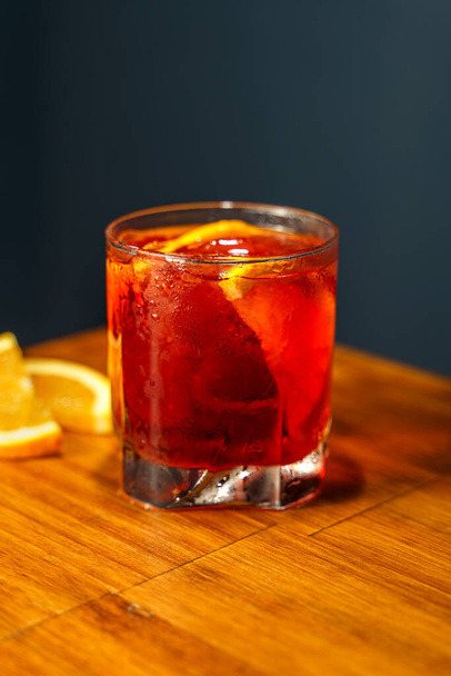 Negroni Cocktail. Gin, Campari and Martini Rosso. Cocktail on wooden bar. - Photo, image