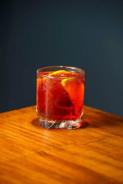 Negroni Cocktail. Gin, Campari and Martini Rosso. Cocktail on wooden bar. - Fotografie, Obrázek