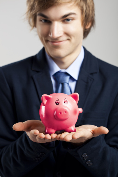 Holding a piggy bank - Photo, image
