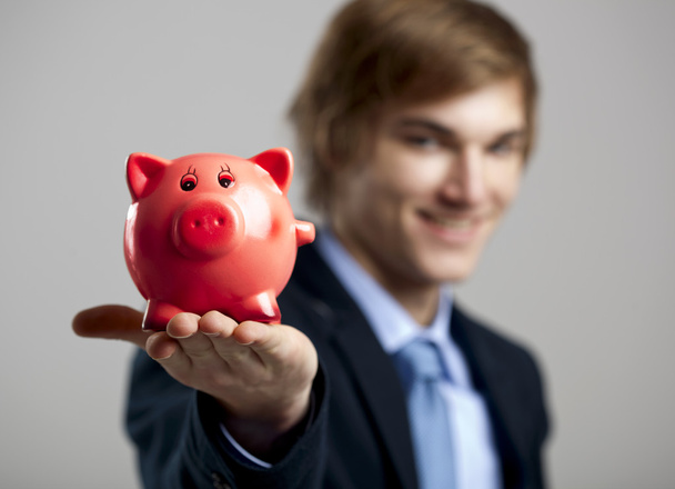 Holding a piggy bank - Zdjęcie, obraz