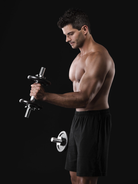 Muscular man lifting weights - Foto, imagen