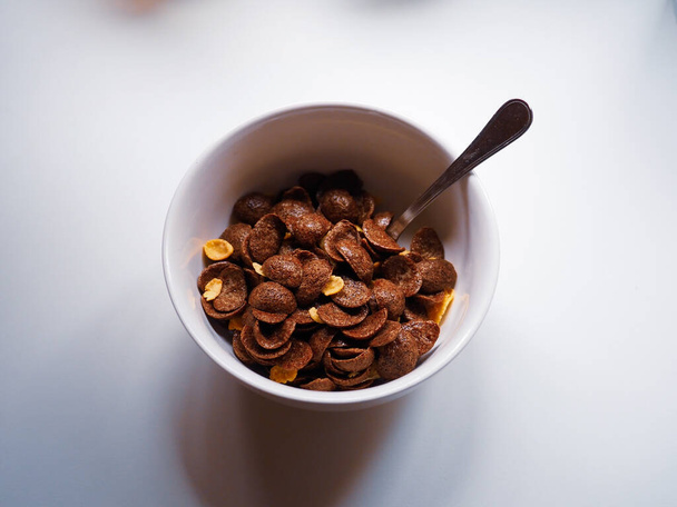 white recipe of chocolate cereals on a white table - Φωτογραφία, εικόνα