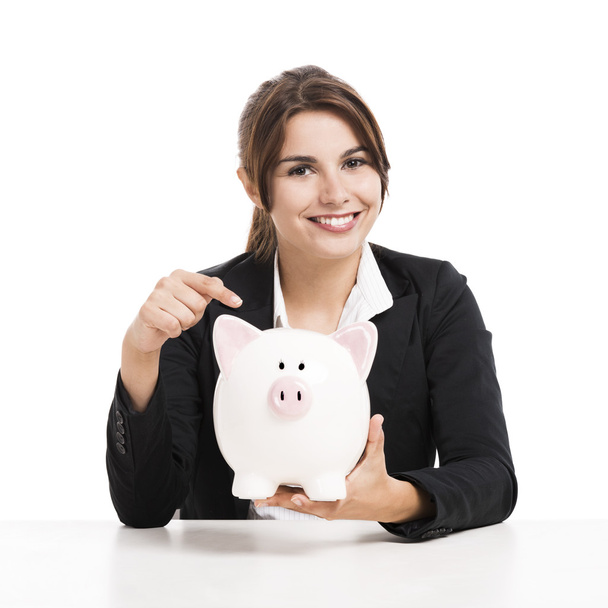 Businesswoman with a piggy bank - Foto, afbeelding