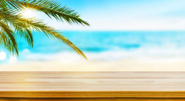 Wood table top on Tropical sea, sand beach and palm leaves background. Mockup for display your products and Travel vacation concept - Valokuva, kuva