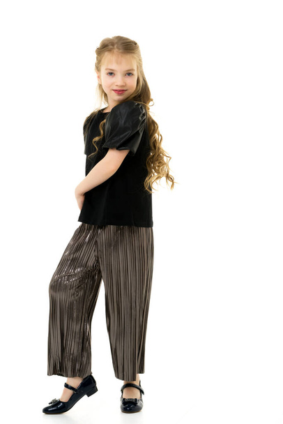 Cute little girl in a pantsuit. Isolated on a white background. - Photo, Image