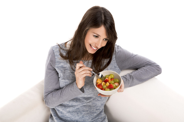 Woman relaxing and eating  fruit salad - Photo, image