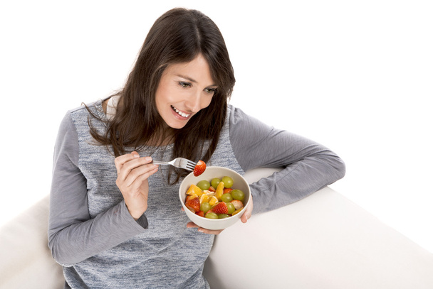 Woman relaxing and eating  fruit salad - Foto, immagini