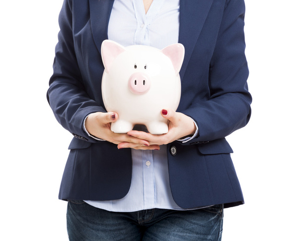 Business woman with a piggy bank - Foto, afbeelding