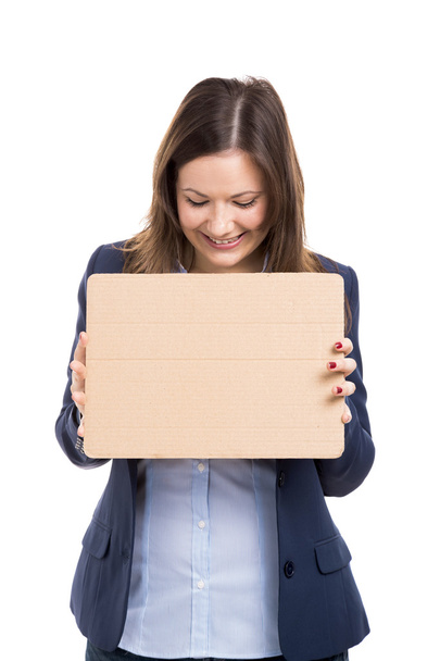 Business woman holding a cardboard - Foto, Imagen