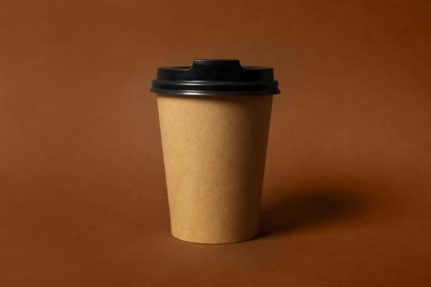 Takeaway paper coffee cup on brown background, closeup - Photo, image