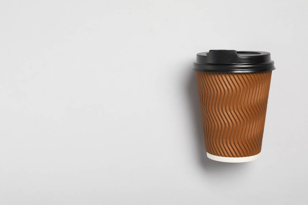 Takeaway paper coffee cup on light grey background, top view. Space for text - Foto, Imagen