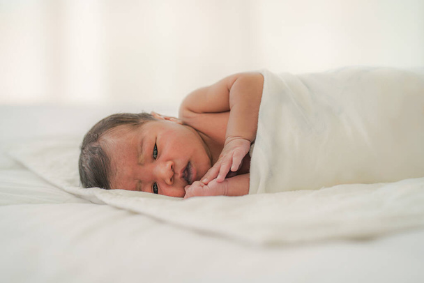 african american new born baby lying on white bed - Photo, Image
