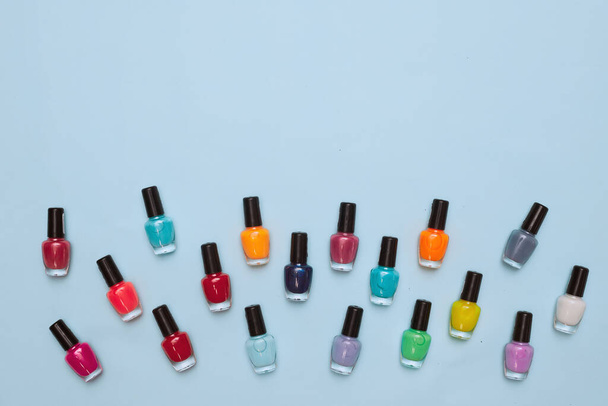 concept, manicure with nail polish, pedicure on blue background, copy space, Flat Lay - 写真・画像