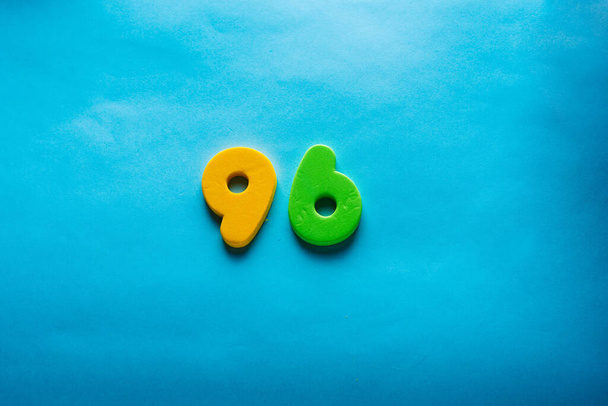 Number on a bright blue background. - 写真・画像