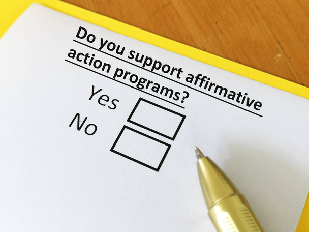 Una persona está respondiendo a la pregunta sobre apoyar programas de acción afirmativa. - Foto, imagen