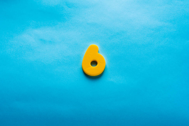Number on a bright blue background. - Фото, изображение